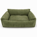 Lodie dog sofa in green corduroy, with padded armrests and backrest